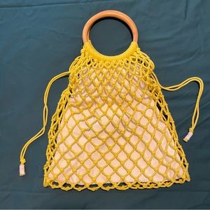 Banana Republic yellow net bag with drawstring liner and wood handles. Like new!